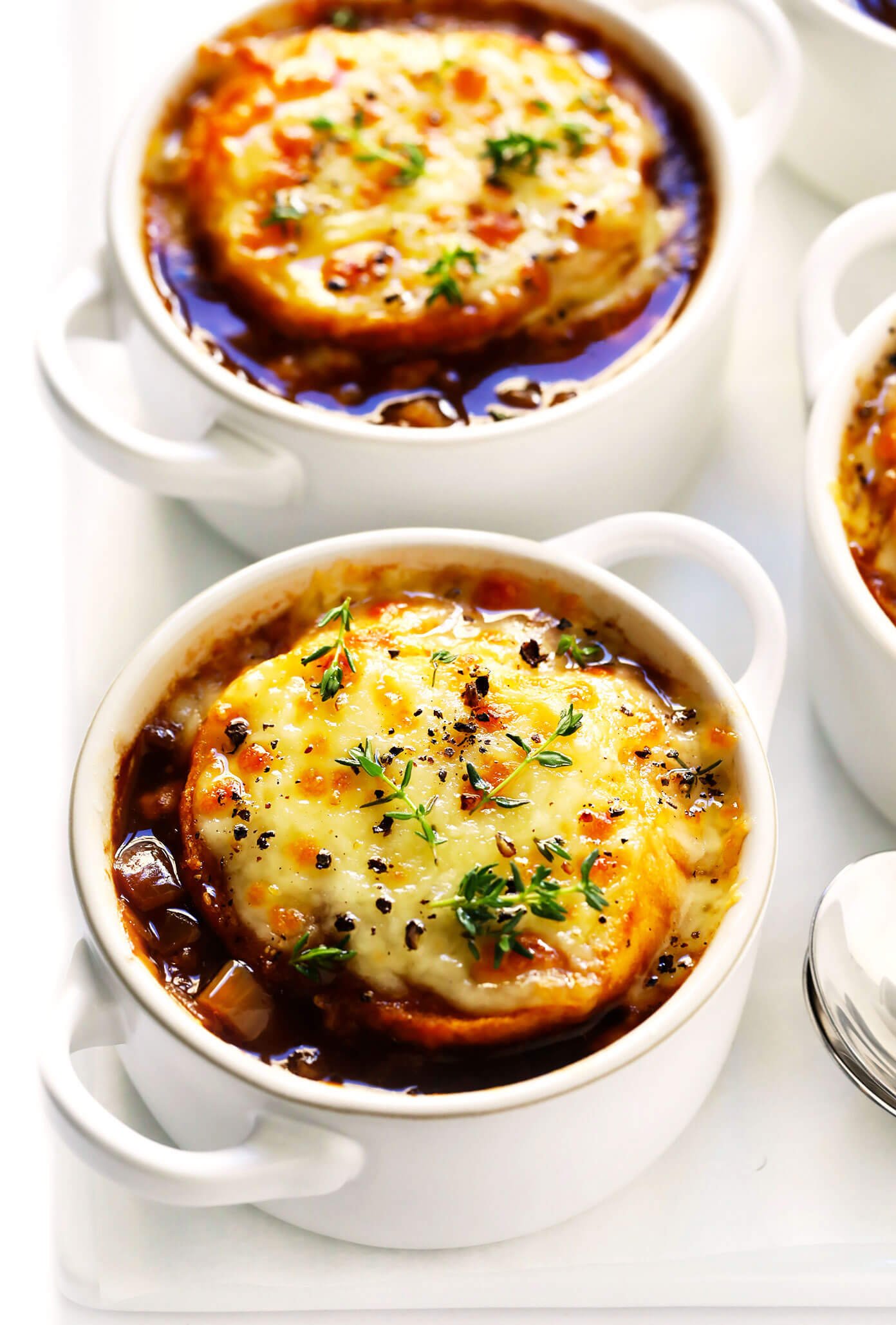 French Onion Soup in Bowls with Melted Cheese and Thyme
