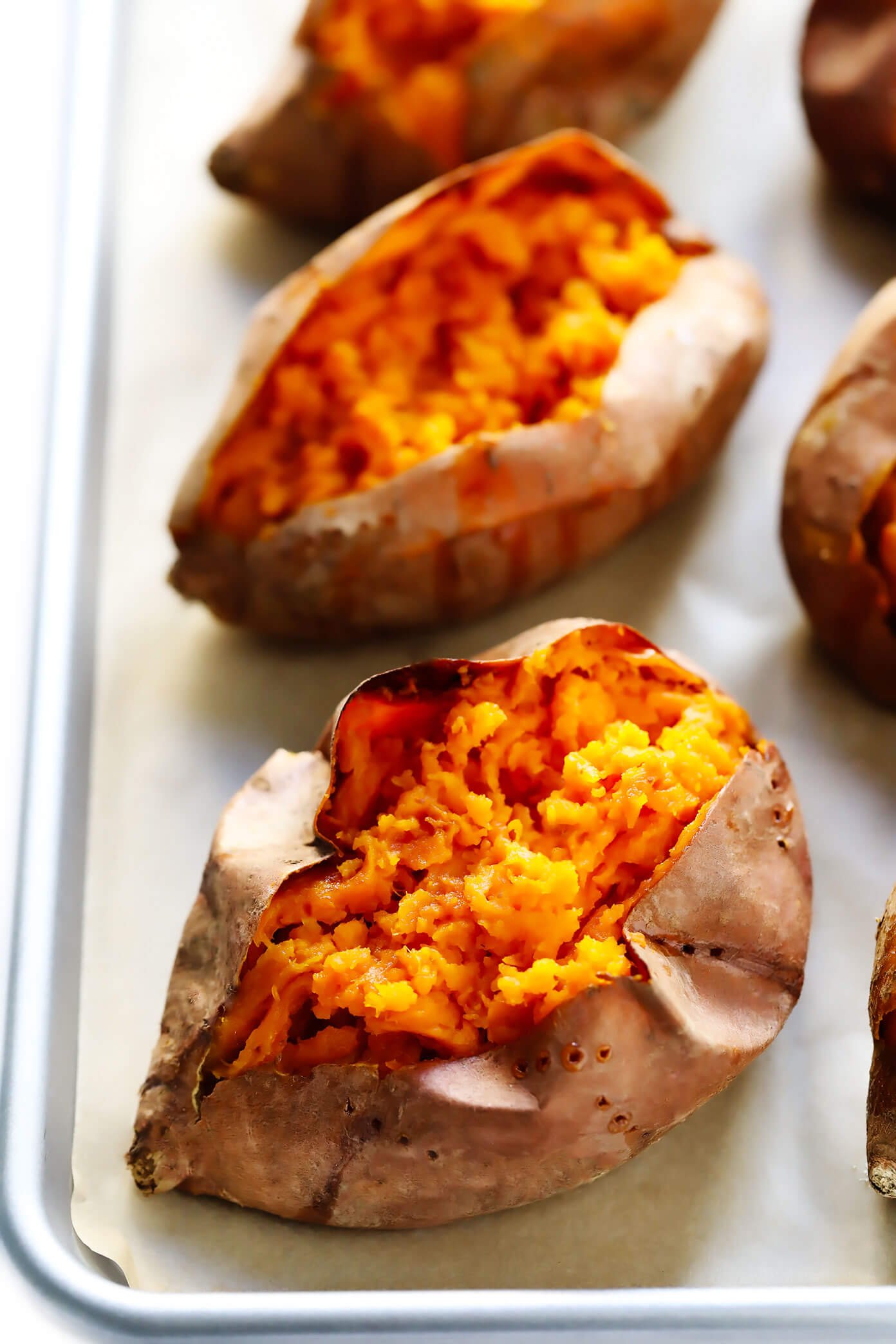 Plain baked sweet potatoes on a baking sheet