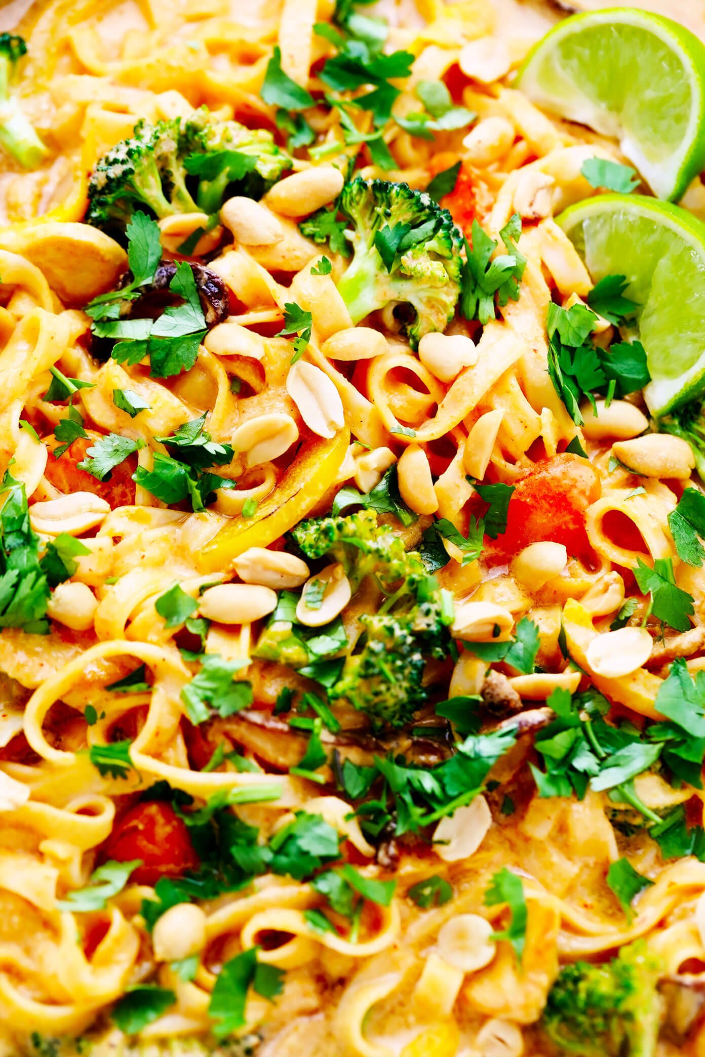 Thai Curry Peanut Noodles Closeup with Limes and Cilantro