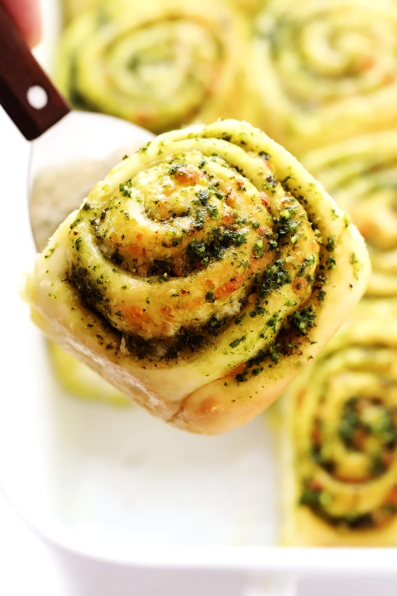 Cheesy Pesto Roll Lifting Out of Pan