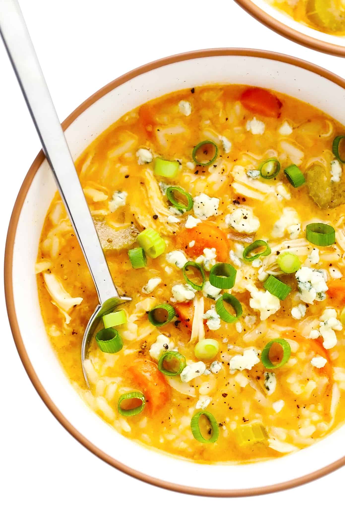 Bowl of buffalo chicken and rice soup with blue cheese