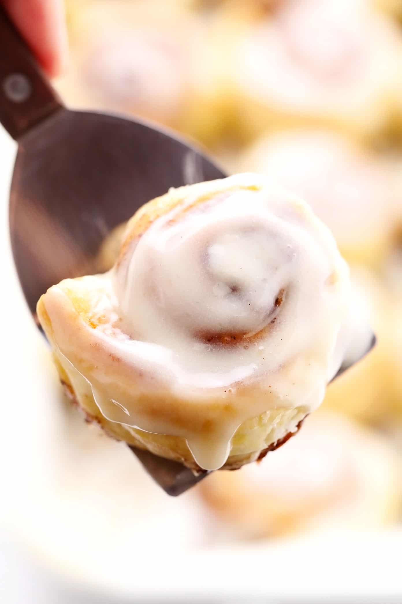 Holding up a puff pastry cinnamon bun