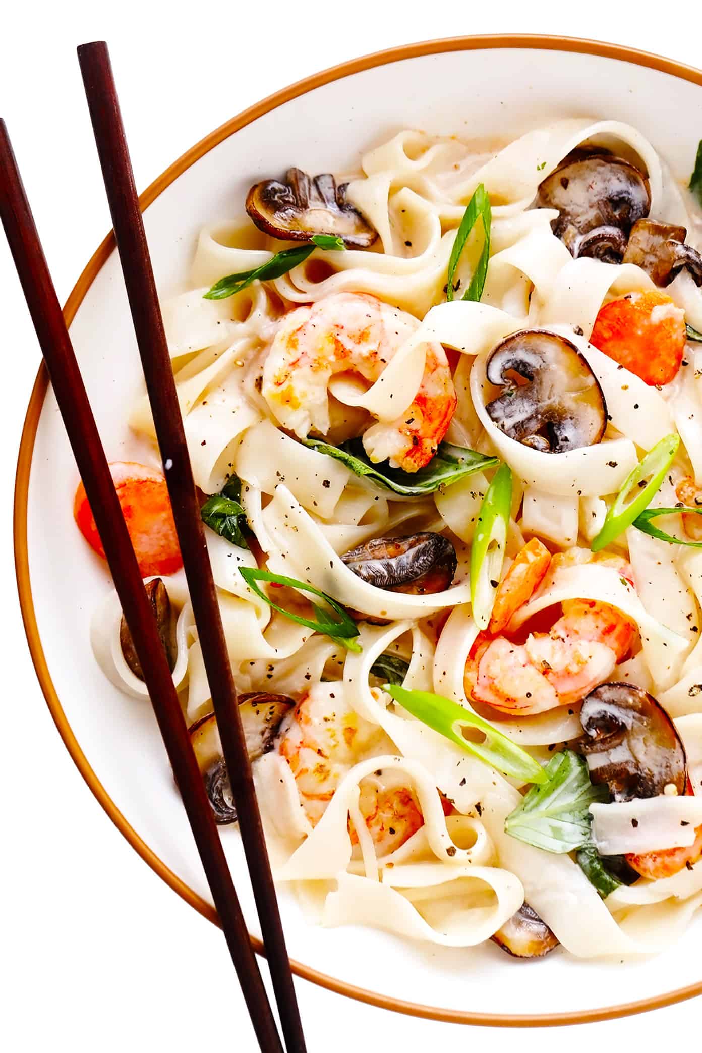 Bowl of lemongrass coconut rice noodles with shrimp and chopsticks