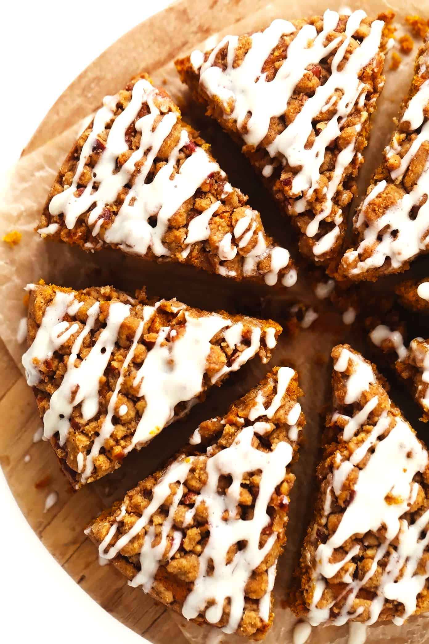 Slices of pumpkin coffee cake with streusel and cream cheese drizzle