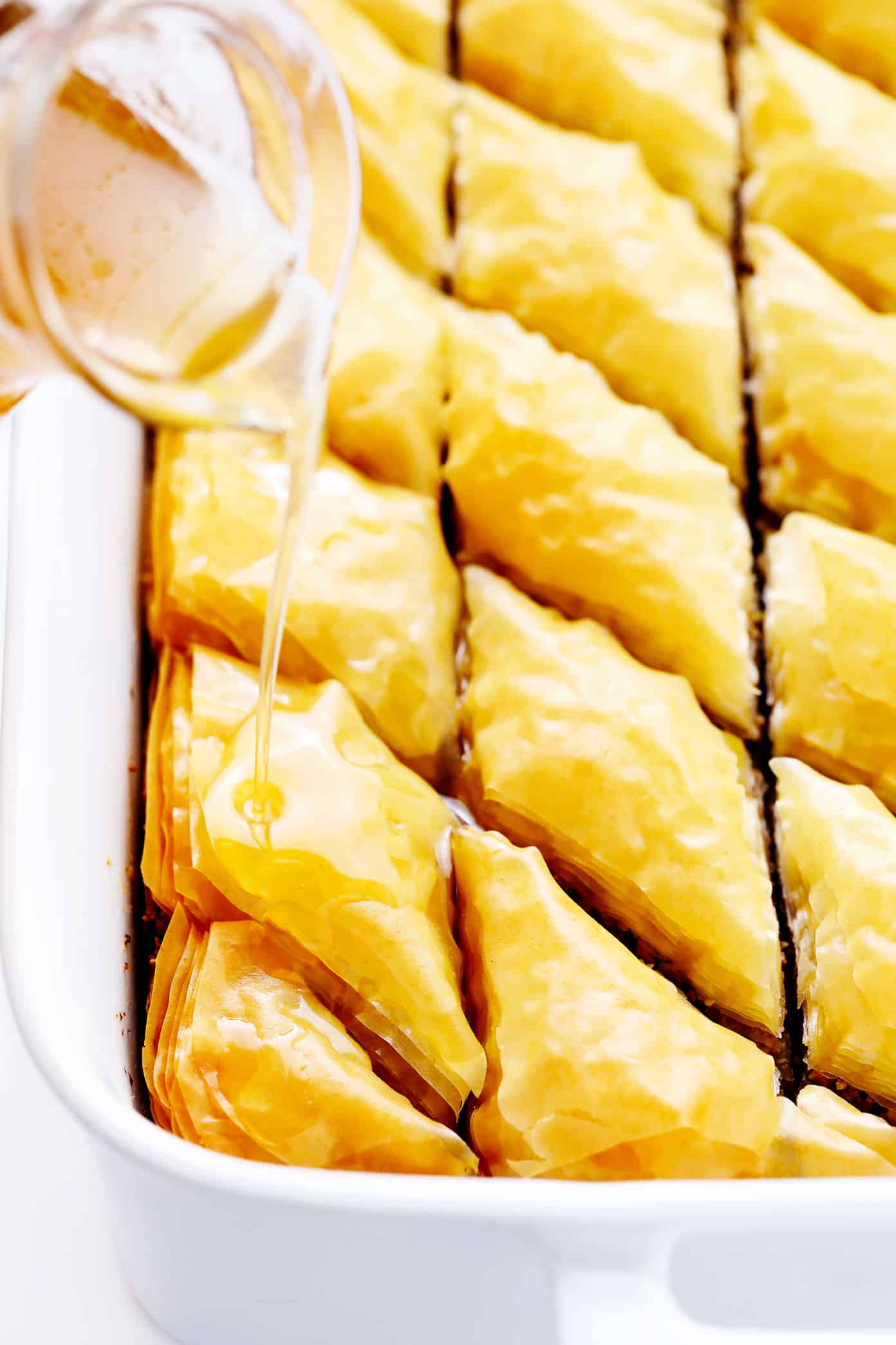 Drizzling cold syrup on hot baklava