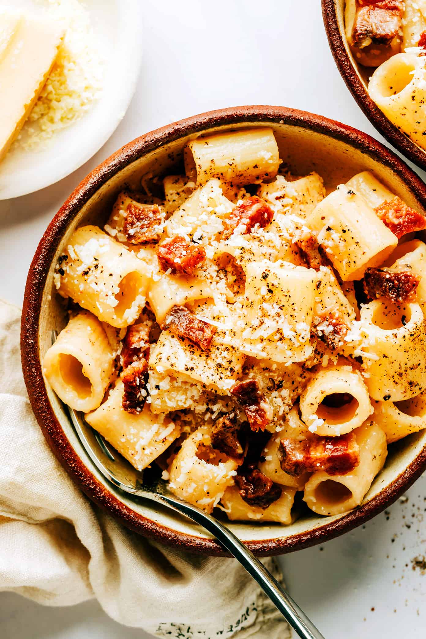 Two serving bowls of pasta alla gricia