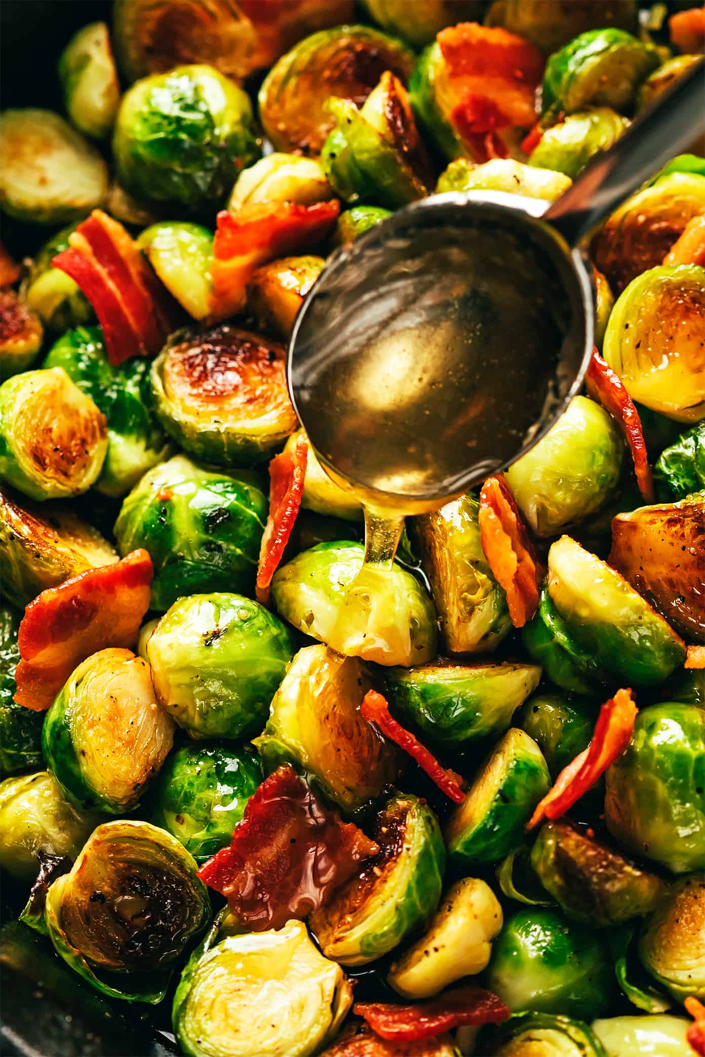 These bacon Brussels sprouts are easy to make and tossed with an irresistible drizzle of hot honey. | gimmesomeoven.com