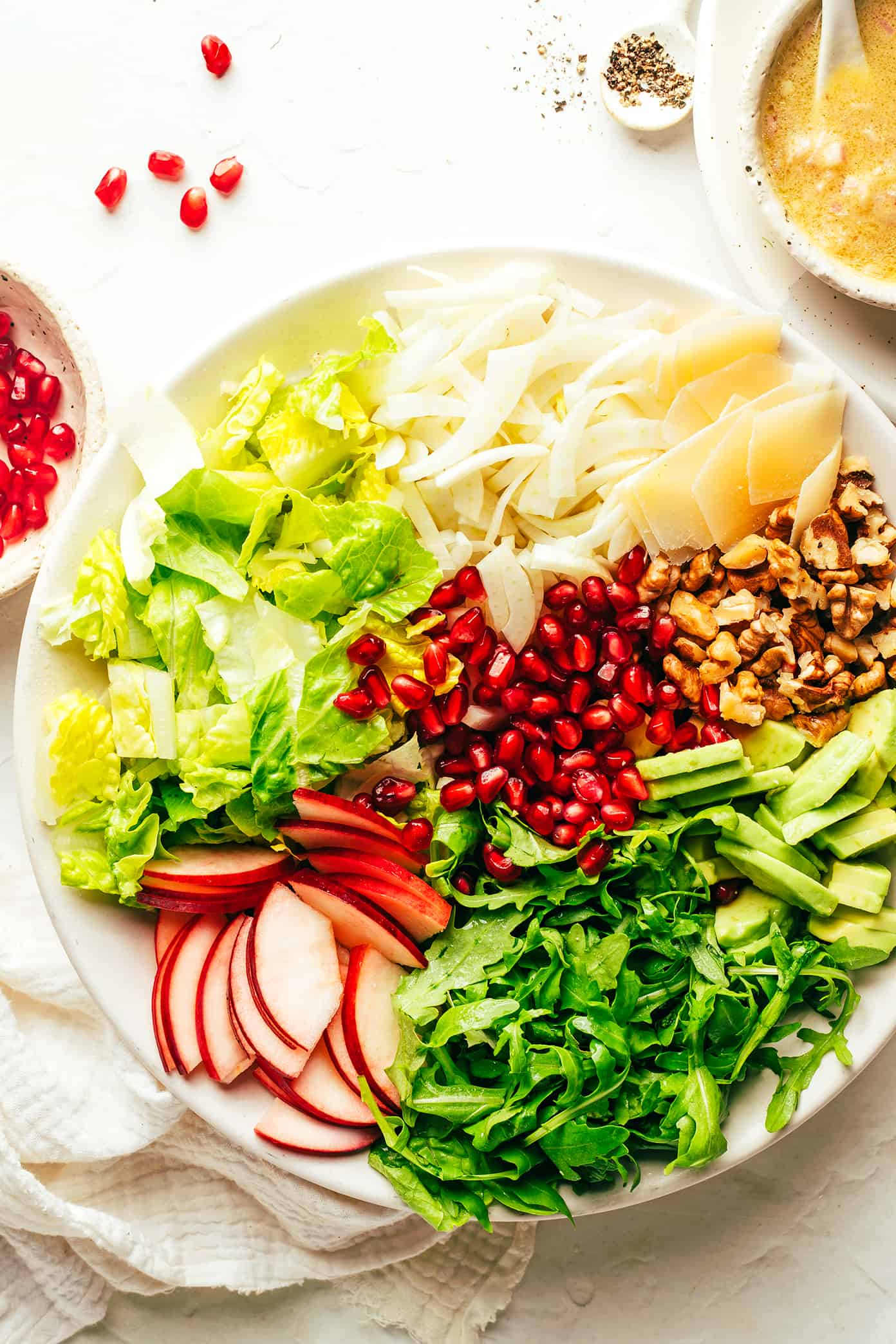 Holiday Green Salad Ingredients (pomegranate, apple, arugula, avocado, walnuts, Parmesan, fennel, lettuce, shallot vinaigrette)