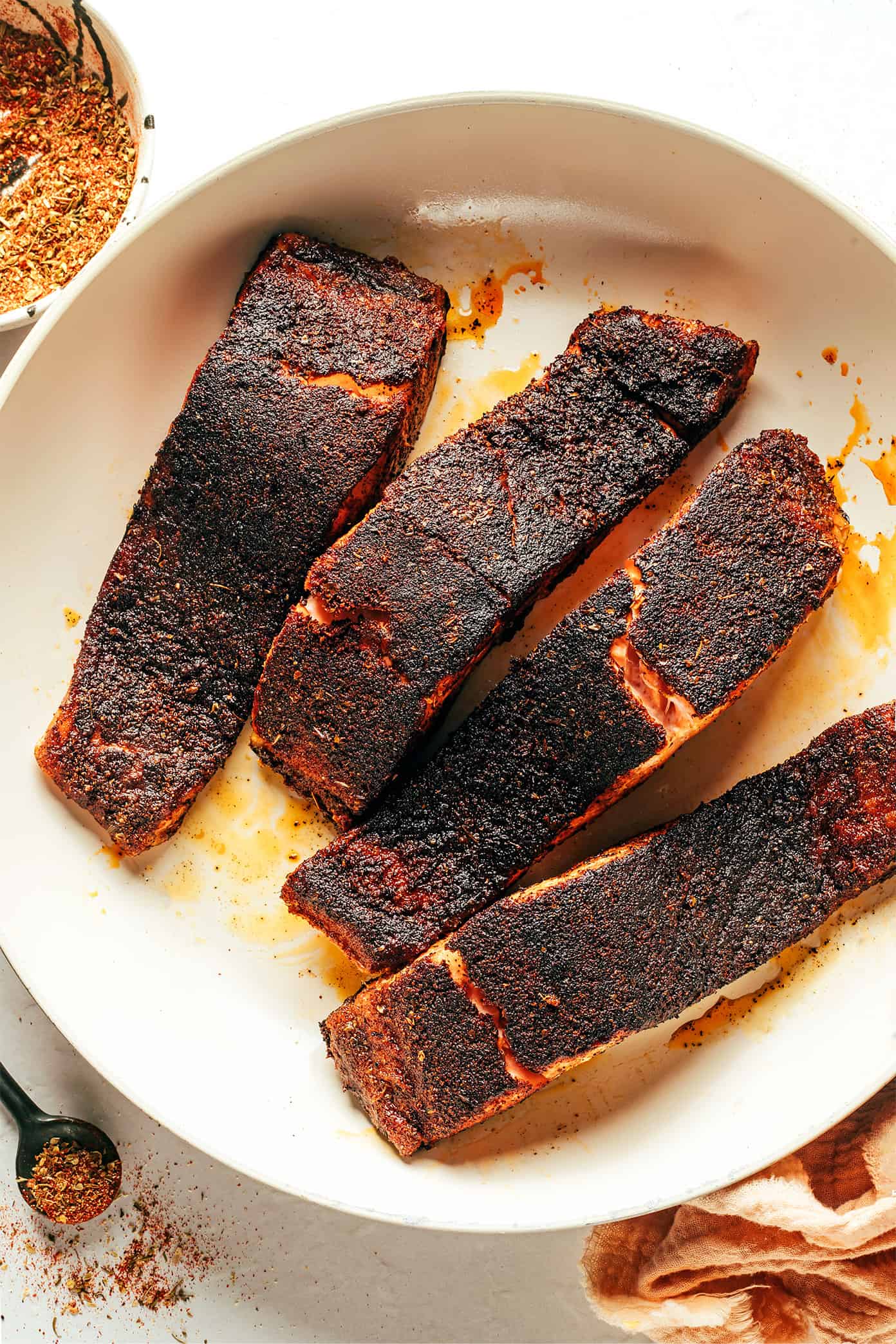 Blackened salmon filets in pan