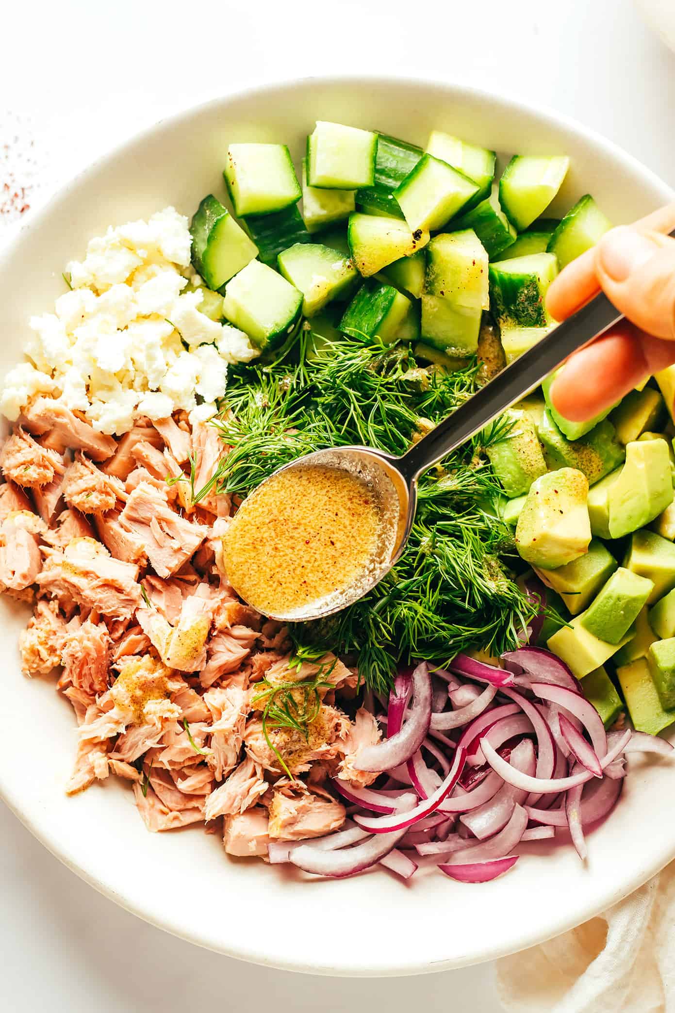 Adding lemon dressing to Tuna Avocado Salad