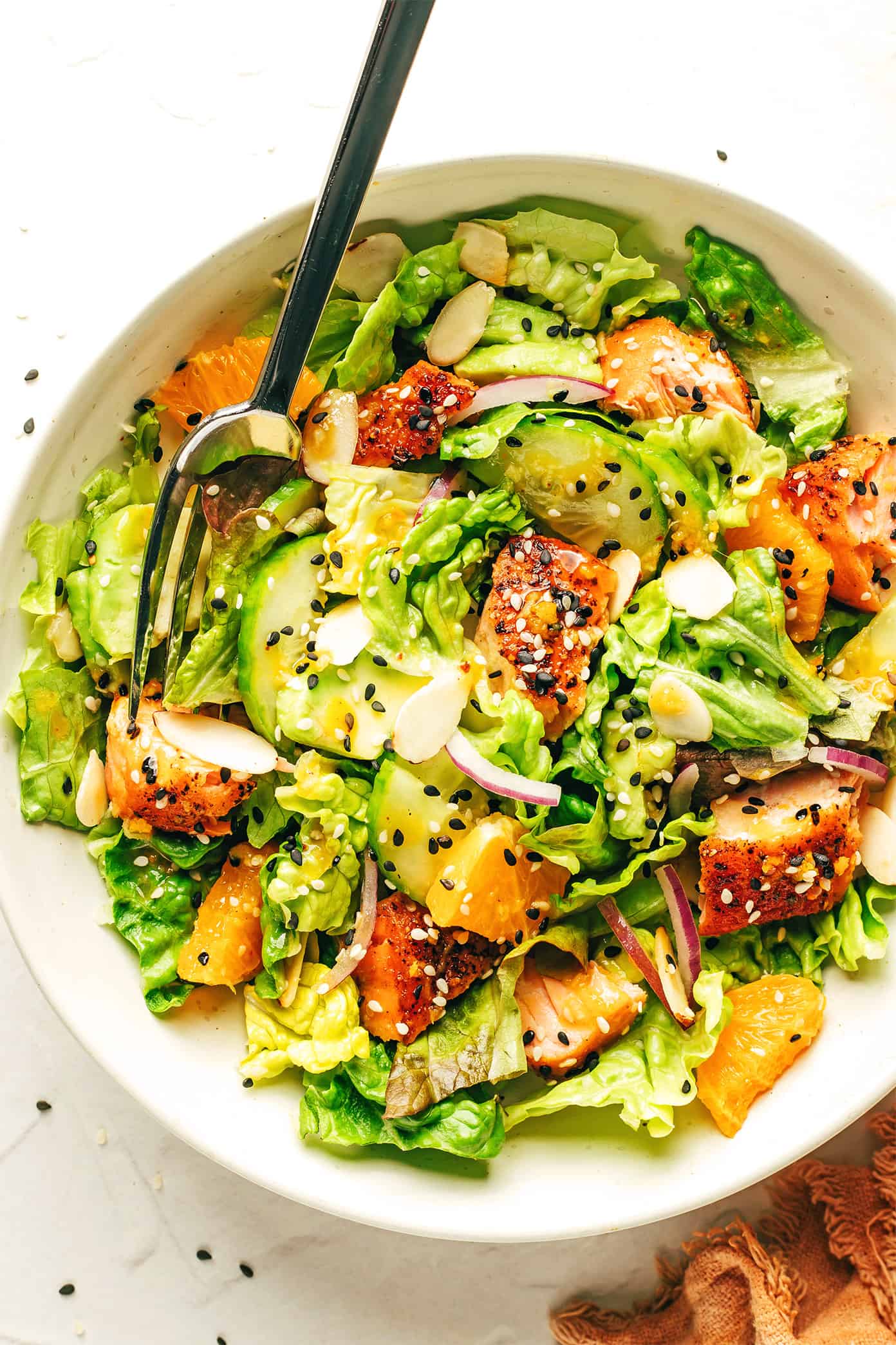 Orange Salmon Salad in serving bowl with ginger hot honey vinaigrette