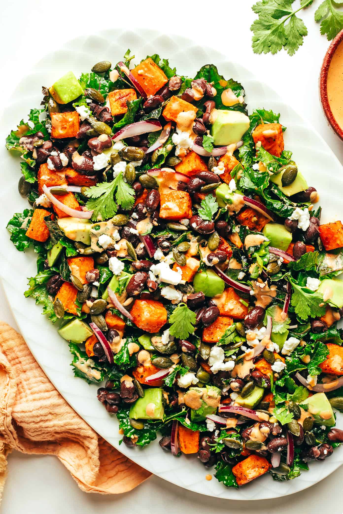 Sweet Potato Avocado Kale Salad with Chipotle Tahini Dressing on Platter