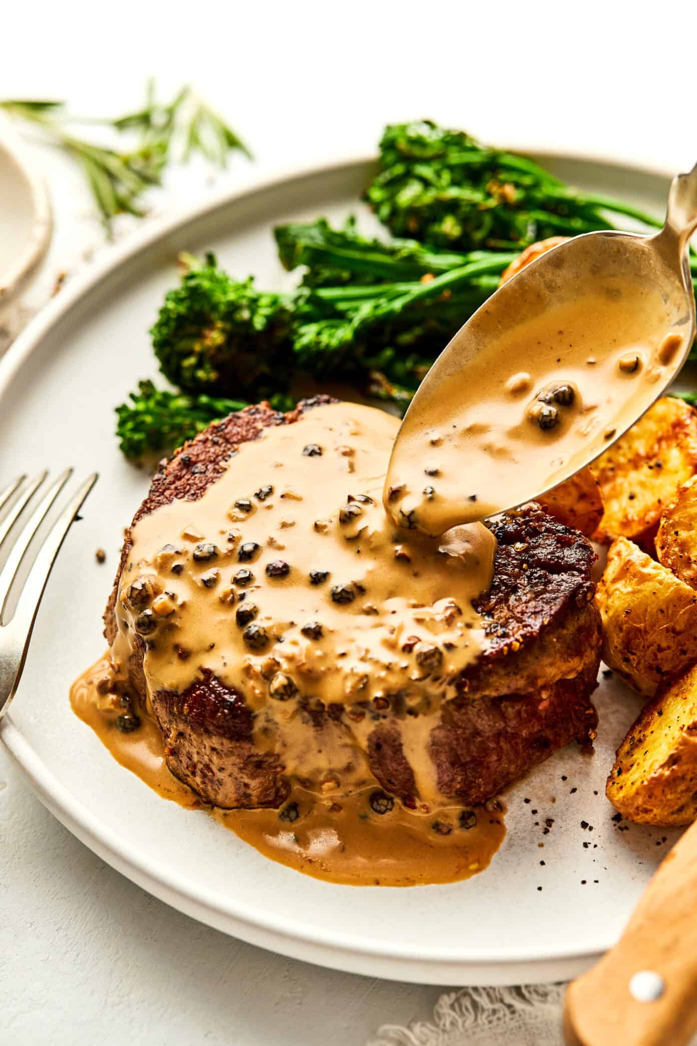 steak with peppercorn sauce on plate