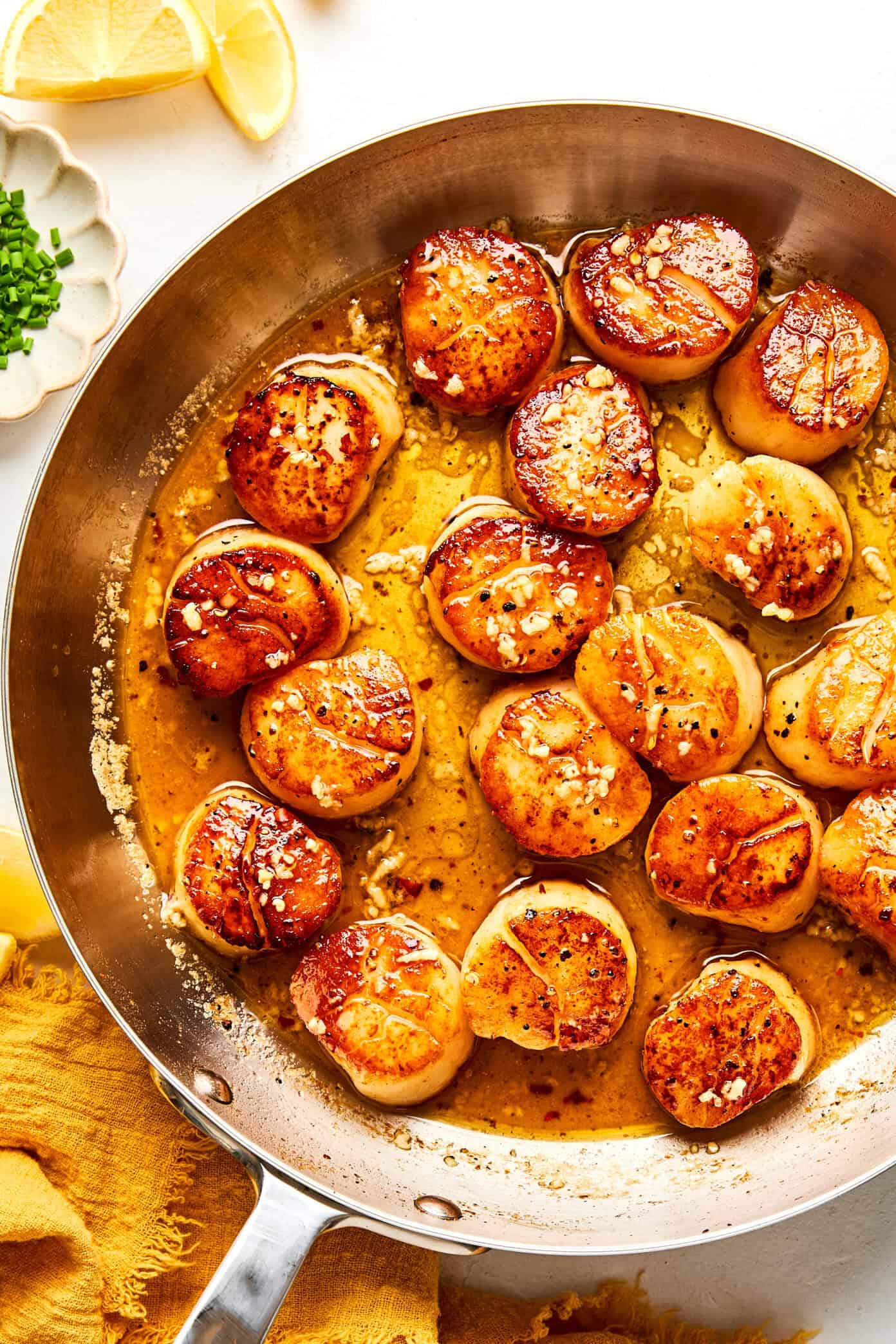 seared scallops in skillet with lemon garlic butter