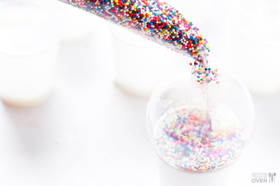 These DIY Sprinkles Ornaments are easy to make and customize with your favorite colors of sprinkles. The perfect homemade decor for your Christmas tree this year! | Gimme Some Oven